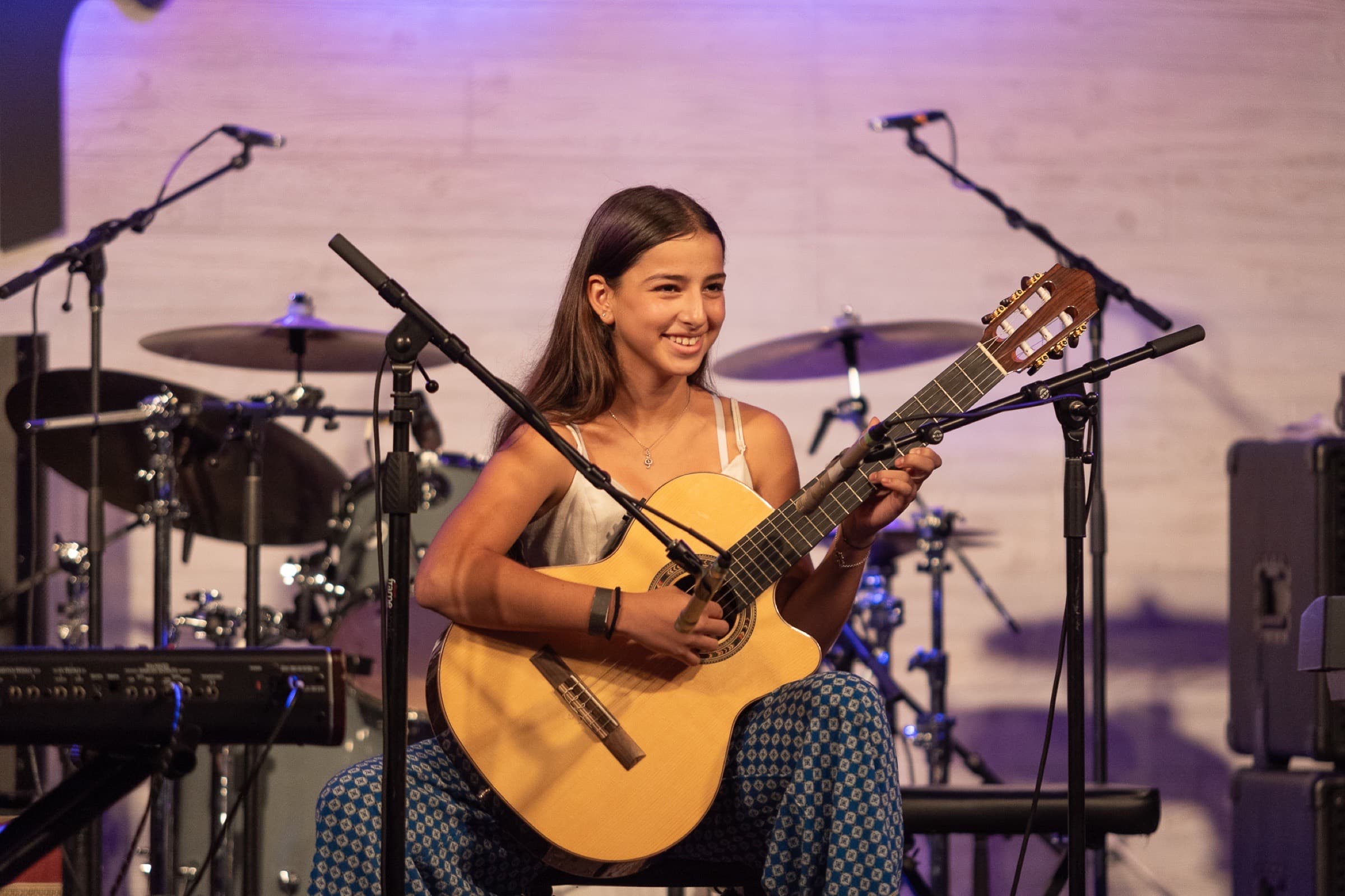 Young guitarist performing live