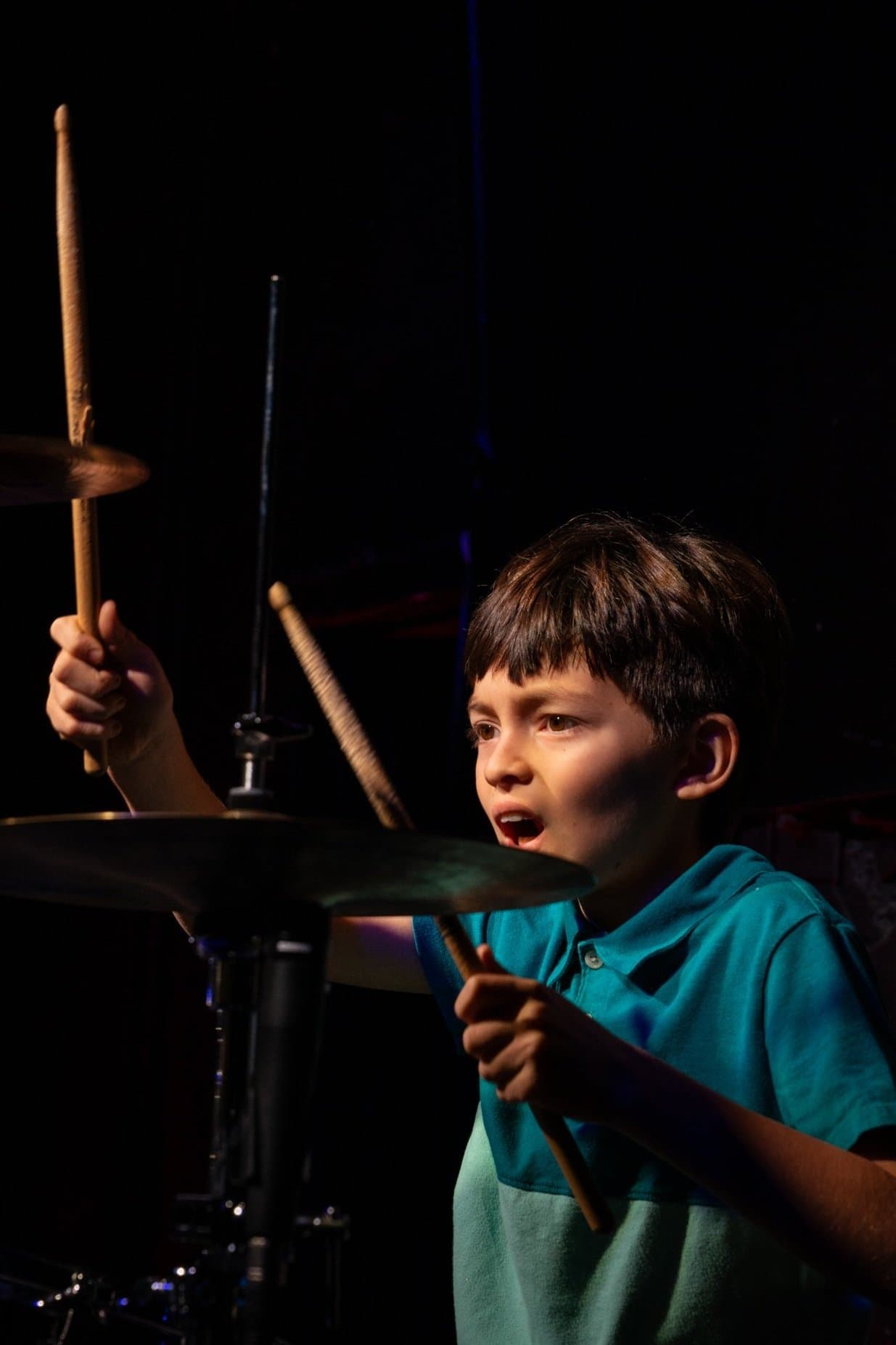 Child playing drums at Wynwood School of Music